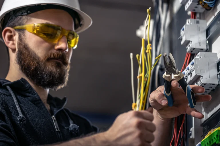 A male electrician works in a switchboard with an 2025 03 31 09 57 18 utc 1 scaled
