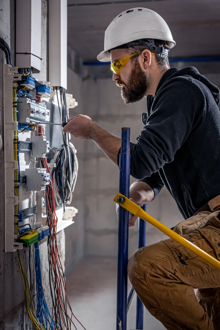 A male electrician works in a switchboard with an 2025 03 16 01 23 04 utc scaled